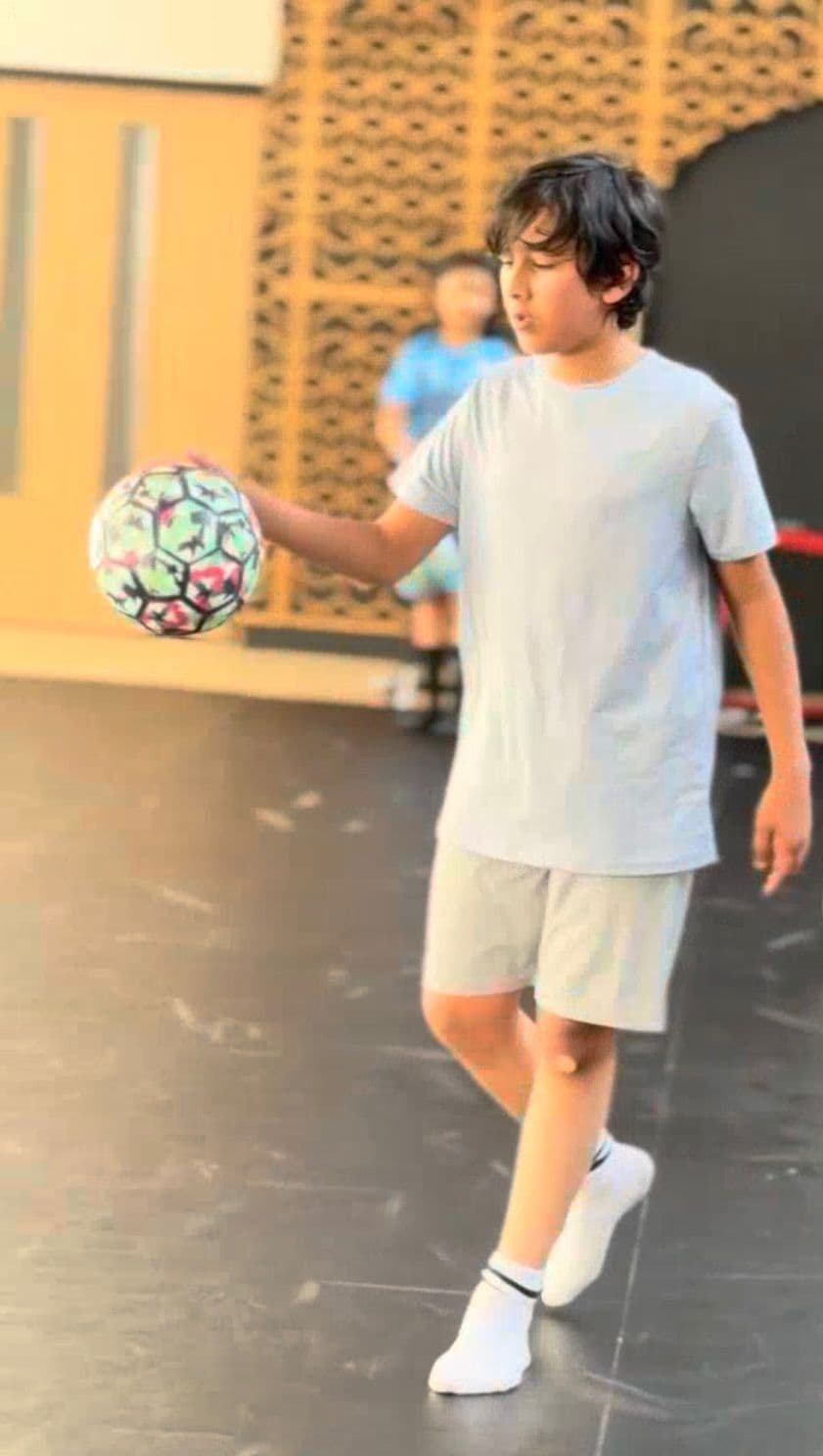 Little Legends player controlling the ball during indoor training