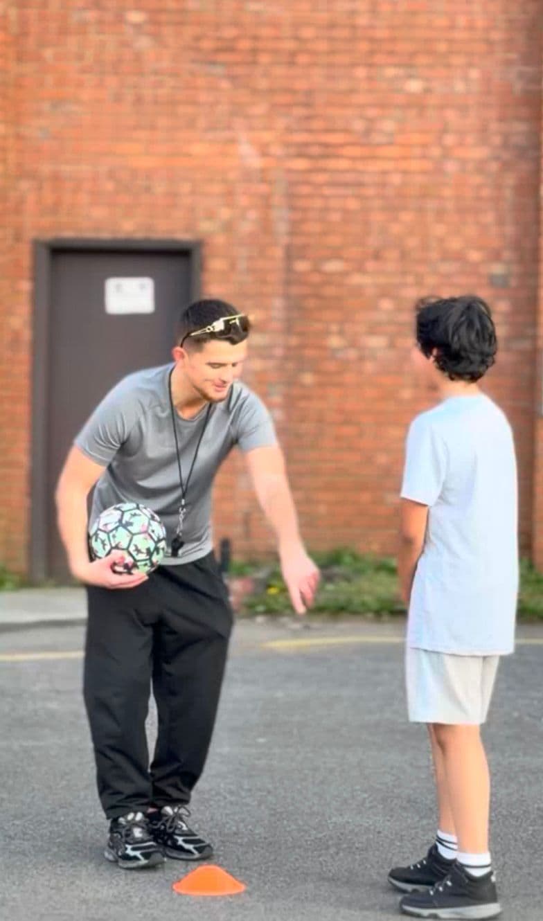 Little Legends coach giving feedback during a football session