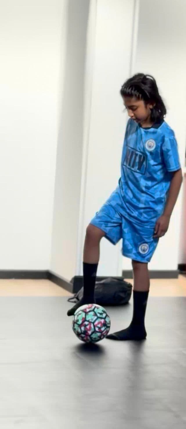 Little Legends player in blue kit practising close control